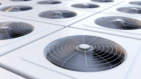Close-up image of a row of commercial HVAC unit fans.