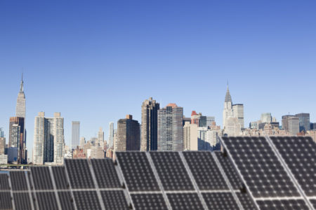 A solar installation for powering green HVAC in the foreground overlooking midtown Manhattan.