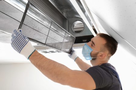 hvac tech cleaning commercial air conditioner